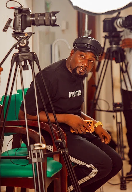 Director seated between cameras on set