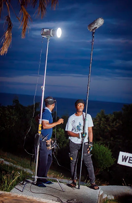Lighting and boom microphone set up for a night shoot