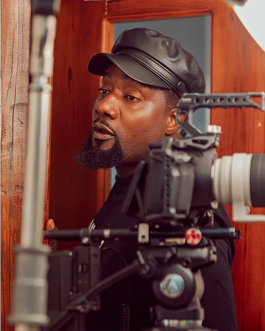 Director framing a shot behind a cinema camera rig