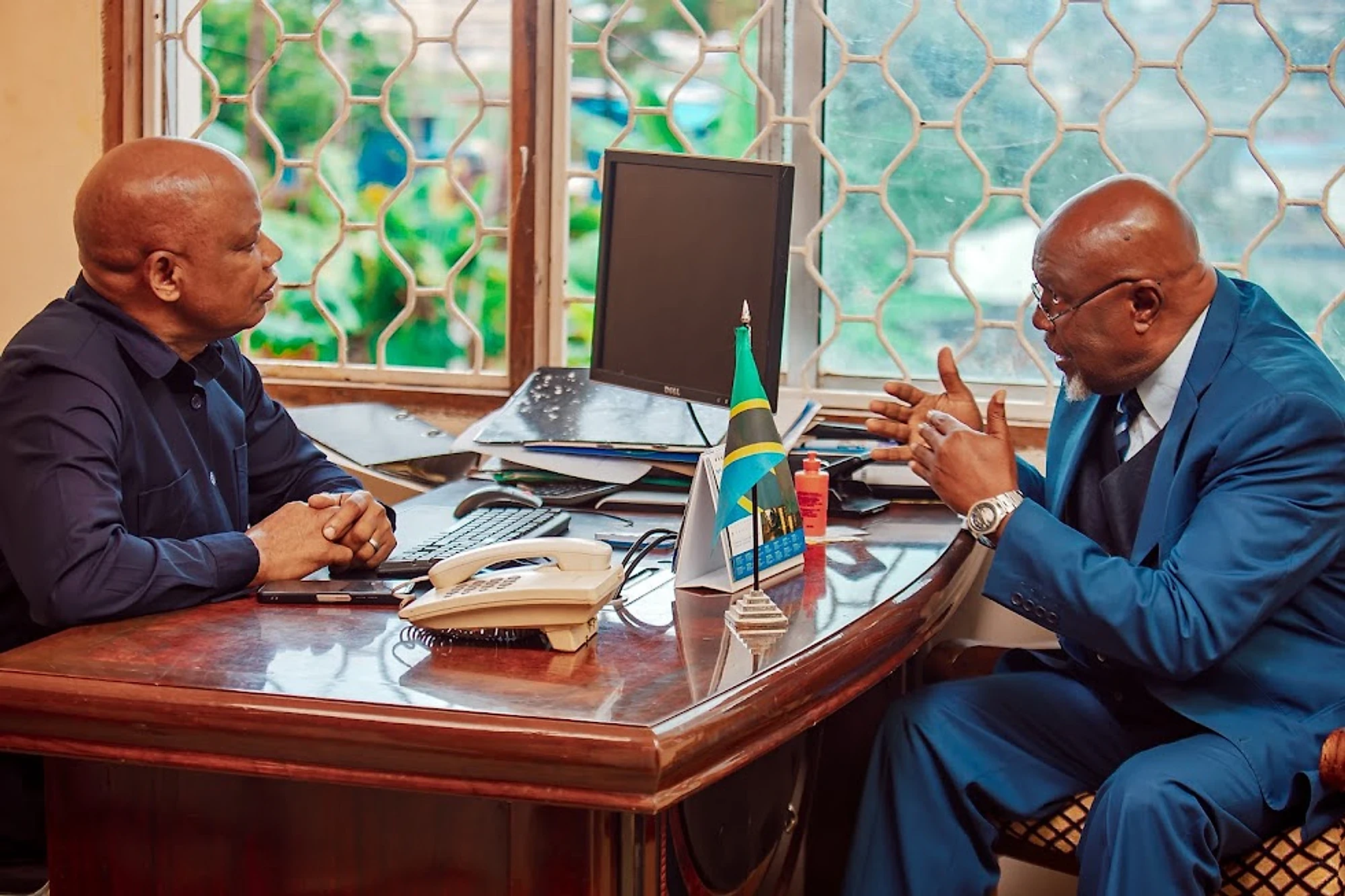 Two officials meeting across a desk